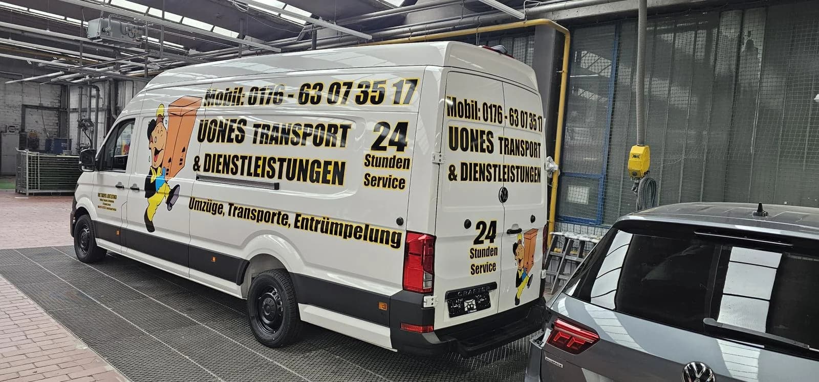 UONES-Transporter von schräg hinten mit Aufschrift „Umzüge, Transporte, Entrümpelung“